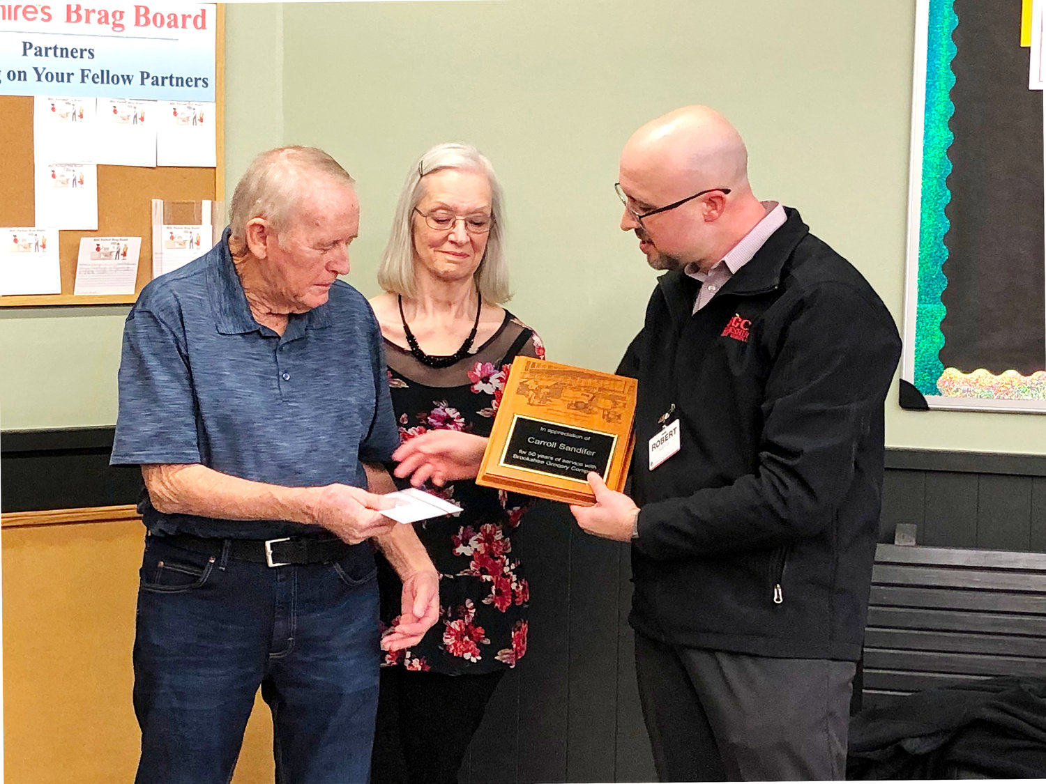 Store manager Robert Marta presented Carroll Wayne Sandifer a plaque and gift for his retirement from Brookshire’s Grocery Store after 50 years as an employee. “We wish you the best in this stage of life,” Marta said. (Monitor photo by Amanda Duncan)